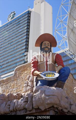 Prospector Statue at Entrance to Fremont Street Experience, Fitzgerald Hotel and Casino in the Background, Las Vegas, USA Stock Photo