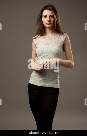 studio shot picture of a young beautiful breast naked woman lying on a