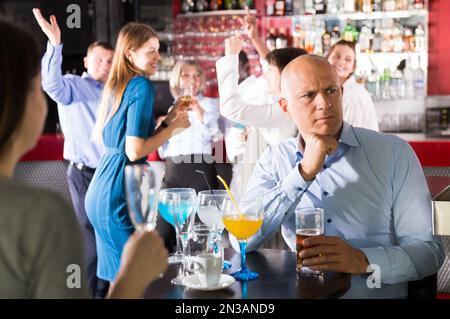Troubled man at office party Stock Photo