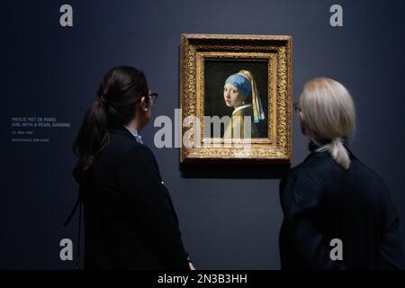 Amsterdam, Netherlands. 7th Feb, 2023. Visitors view the artwork Girl with a Pearl Earring by Dutch painter Johannes Vermeer during a press preview of an exhibition at Rijksmuseum in Amsterdam, the Netherlands, on Feb. 7, 2023. With loans from all over the world, the exhibition is expected to be the largest Vermeer exhibition ever and is scheduled to open to the public from Feb. 10 to June 4. Credit: Sylvia Lederer/Xinhua/Alamy Live News Stock Photo