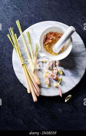 Lemongrass still life on a marble cutting board with mortar and pestle Stock Photo