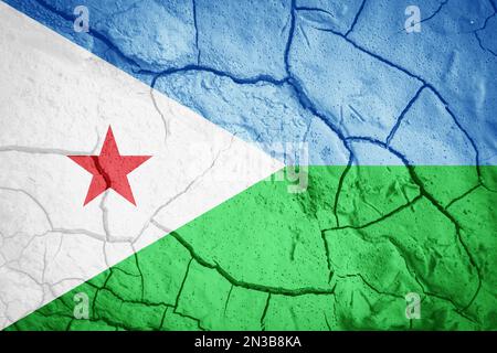 Flag of Djibouti. Djibouti symbol. Flag on the background of dry cracked earth. Djibouti flag with drought concept Stock Photo