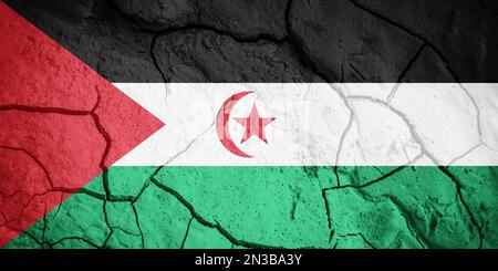 Flag of  Sahrawi Arab Democratic Republic. Sahrawi symbol. Flag on the background of dry cracked earth. Sahrawi Arab Democratic Republic flag with dro Stock Photo