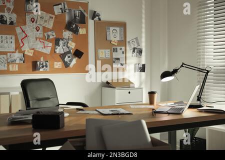 Detective office interior with big wooden desk and evidence board Stock Photo