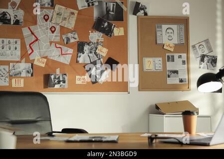 Detective office interior with big wooden desk and evidence board Stock Photo