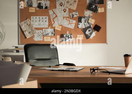 Detective office interior with big wooden desk and evidence board Stock Photo