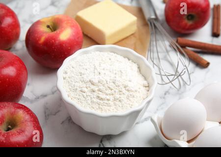 Traditional English apple pie ingredients on white marble table, closeup Stock Photo