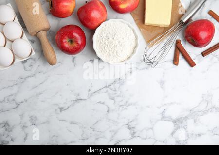 Traditional English apple pie ingredients on white marble table, flat lay. Space for text Stock Photo