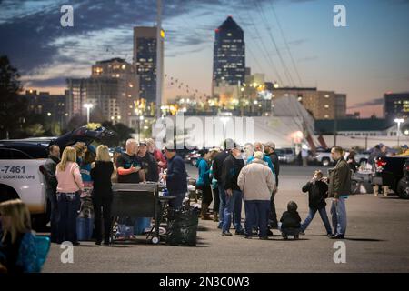 Jacksonville Jaguars fans tailgate in a parking lot outside the stadium  before an NFL football game against the Tennessee Titans, Saturday, Jan. 7,  2023, in Jacksonville, Fla. (AP Photo/Phelan M. Ebenhack Stock