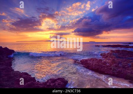 Beautiful sunset at Maui Wai or Secret Beach; Makena, Maui, Hawaii, United States of America Stock Photo