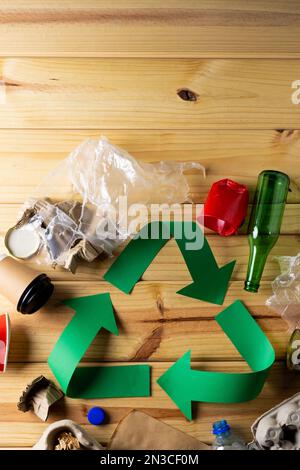 Close up of recycling symbol of paper green arrows and paper, glass trash with copy space Stock Photo