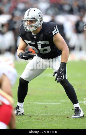 Oakland Raiders defensive end Justin Tuck (91), middle linebacker Miles  Burris (56) and safety Charles Woodson (24) surround Kansas City Chiefs  tight end Travis Kelce (87) as he picks up a first