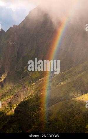 Rainbow over Pu'u o Kila lookout on Kauai, a spectacular location that gives a panoramic view of Kalalau Valley Stock Photo