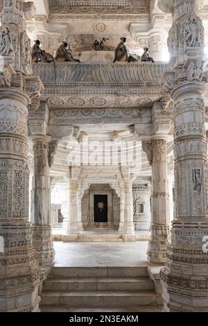 Monkeys resting inside on an intricately carved, interior balcony at the Jain Temple at Ranakpur; Ranakpur, Rajasthan, India Stock Photo