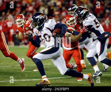 Denver Broncos linebacker Keith Burns jokes with teammates as the