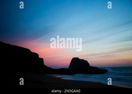 The sun sets over Panther Beach in Central California. Stock Photo