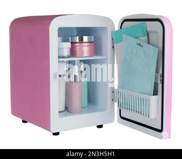 Pink cosmetics refrigerator with skin care products isolated on white Stock Photo