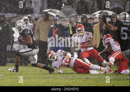 Oakland Raiders Charles Woodson (24) goes high to intercept a