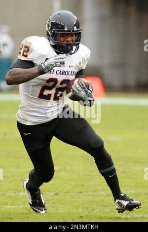 East Carolina running back Chris Hairston (22) rushes for yardage past  Florida linebacker Jarrad Davis (40) and Justus Reed (97) during the first  half of an NCAA college football game in Gainesville