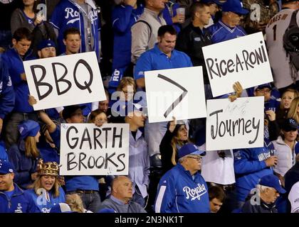 Kansas City Royals fans hold up pictures of starting pitcher Johnny Cueto  and catcher Salvador Perez as he Royals face the New York Mets in game 2 of  the World Series at