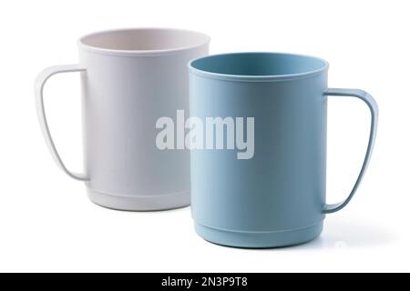 Two plastic mugs of different colors isolated on white background Stock Photo