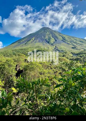 A view of the Arenal Volcano near La Fortuna Costa Rica on a clear day with light cloud near the top Stock Photo