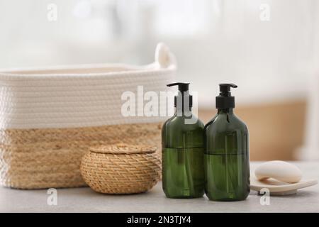 Green soap dispensers on white countertop in bathroom Stock Photo