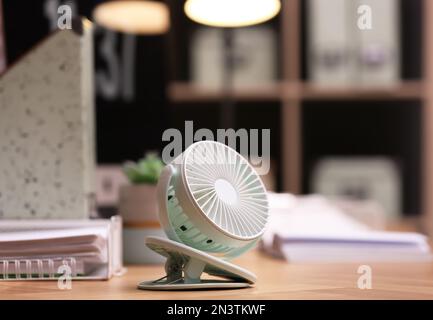 Modern electric fan on table in office Stock Photo