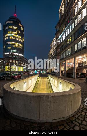 Driveway of a car park between two office buildings in the evening with beautiful lighting, Hamburg, Germany Stock Photo