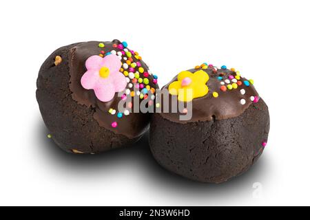 Choc balls or chocolate balls topping with multicolored rainbow sprinkles and colored sugar flower isolated on white background with clipping path Stock Photo