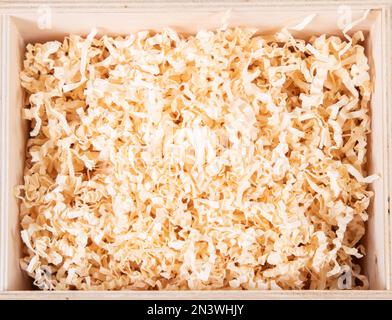 packing wood shavings chips on white background on fiber carton recycled Stock Photo