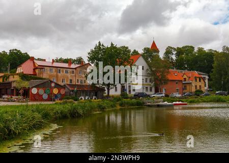 TALSI, LATVIA, SEPTEMBER 10, 2022: Colorful old town houses and church with lake reflection in Talsi Latvia. Stock Photo