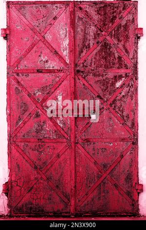 Old rusty, doors on a white wall Stock Photo