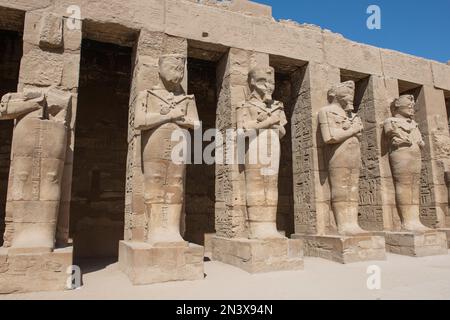 Large statues of Ramses III in ancient egyptian Karnak Temple with ...