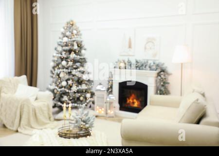 Blurred view of fireplace in living room decorated for Christmas Stock Photo