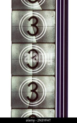 Film roll. Detail from a roll of film in it's starting sequence with numbers counting down from 10 that was shown when projecting the film on a screen. The number three in different phases are seen on the frames of the film roll. 1950s Stock Photo