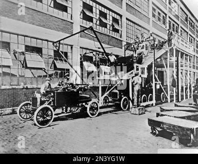 Ford history. It's factory in Highland park Michigan USA was a production facility for the Model T car and has become known for being the first factory in history to assemble cars on a moving assembly line. The bodies of the cars are slided down onto the chassis that moves forward on a line. 1914 Stock Photo