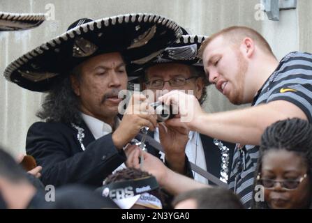 Fans wearing sombreros are in the stands during the NFL Hispanic