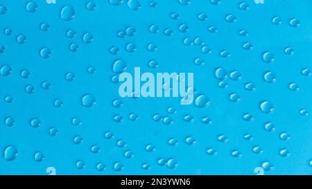 A water drop on a blue background. Stock Photo
