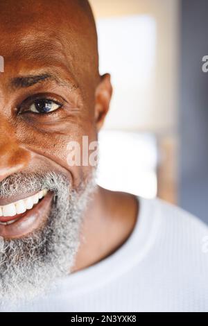 Cropped image of african american bald senior man smiling in log cabin Stock Photo