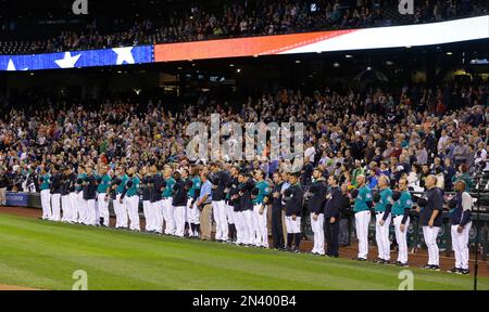 Los Angeles Angels players stand in front of the dugout before a game  against the Texas Rangers at Globe Life Field in Arlington, Texas, on April  15, 2022, wearing Jackie Robinson's No.