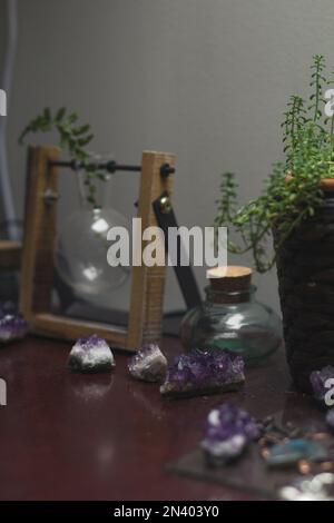 Close up cozy desk decoration with crystals and empty bottles concept photo Stock Photo