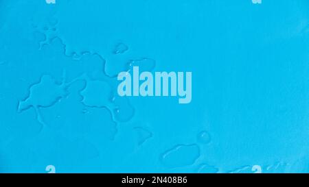 A water drop on a blue background. Stock Photo