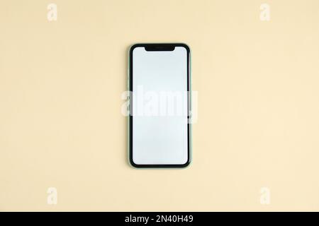 MYKOLAIV, UKRAINE - JULY 10, 2020: Iphone 11 with white paper image on screen, top view Stock Photo