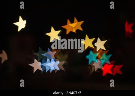 Star shape background bokeh blurred,many objects, colored red yellow orange blue, glow moving, car lights on the road blur, at night. concept backgrou Stock Photo