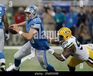 Detroit Lions Matthew Stafford is pursued by San Diego Chargers Vaughn  Martin during the third quarter in Detroit on December 24, 2011. The Lions  beat the Chargers 38-10. With the win the