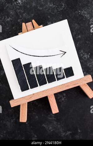 when will inflation go down. canvas with graph showing prices dropping, cost of living going down conceptual image Stock Photo