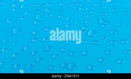 A water drop on a blue background. Stock Photo