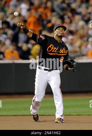 Baltimore Orioles third baseman Jimmy Paredes wipes pie from his face after  teammate Adam Jones threw a pie in his face in celebration after Paredes  hit the game winning RBI double in