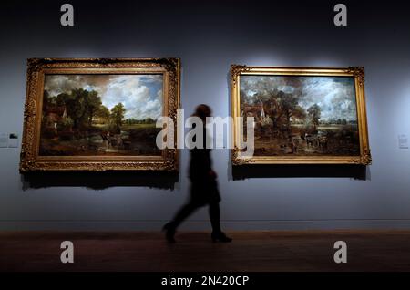 A Victoria and Albert Museum press officer walks past John Constable's The Hay Wain, left, towards the full oil sketch of the same scene at an exhibition entitled: 'Constable: The Making of a Master ' with works by British landscape painter John Constable, during a preview in London, Wednesday, Sept. 17, 2014. Best-known to many for ‘The Hay Wain’ - an artwork which adorns countless decorative plates and trays, the exhibition explores Constable’s influences and takes a look at the creative process behind some of his most famous works. The exhibition will run from Sept. 20, 2014 to Jan. 11. 201